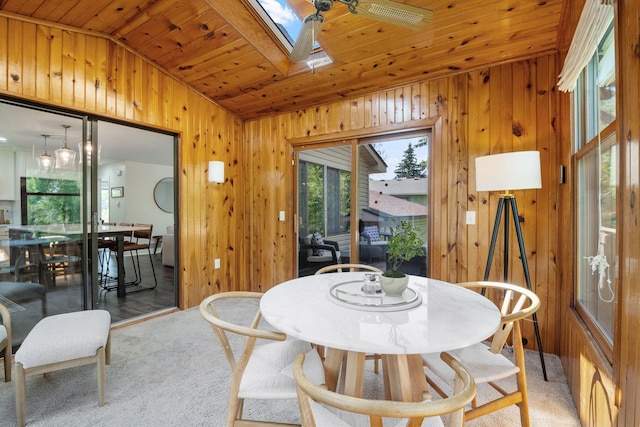 9645 Garrison Way, Eden Prairie, MN 55347 - dining area featuring lofted ceiling, wood ceiling, wooden walls, light colored carpet, and a skylight