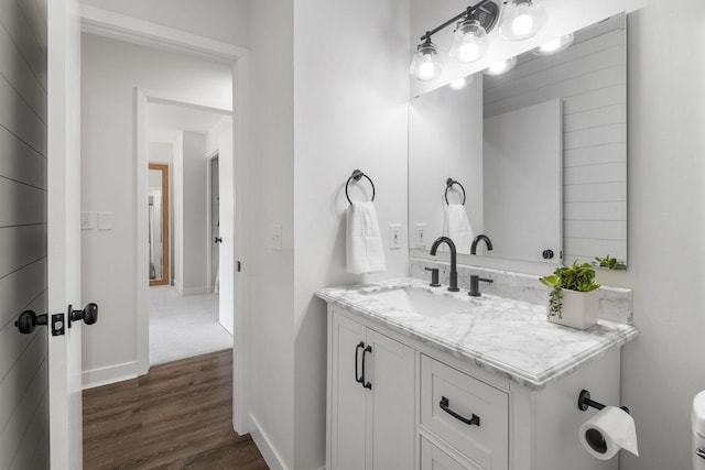 9645 Garrison Way, Eden Prairie, MN 55347 - bathroom featuring wood finished floors, vanity, baseboards, and toilet