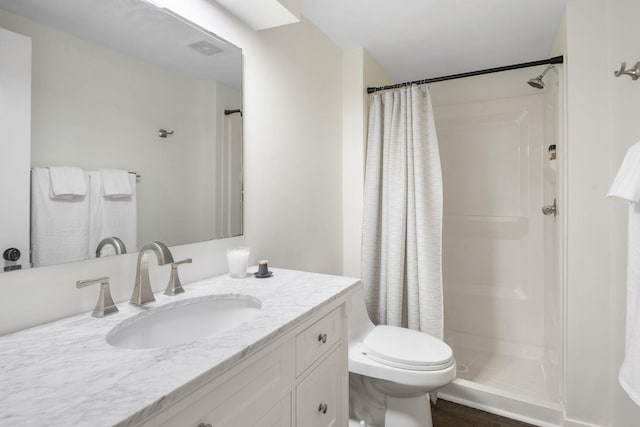 9645 Garrison Way, Eden Prairie, MN 55347 - bathroom with vanity, a shower with shower curtain, and wood finished floors