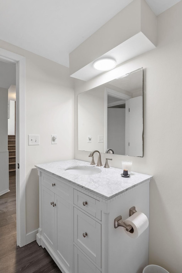 9645 Garrison Way, Eden Prairie, MN 55347 - bathroom featuring wood finished floors, vanity, and baseboards