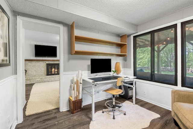 9645 Garrison Way, Eden Prairie, MN 55347 - office area featuring a fireplace, dark wood-style flooring, a textured ceiling, a wainscoted wall, and a decorative wall