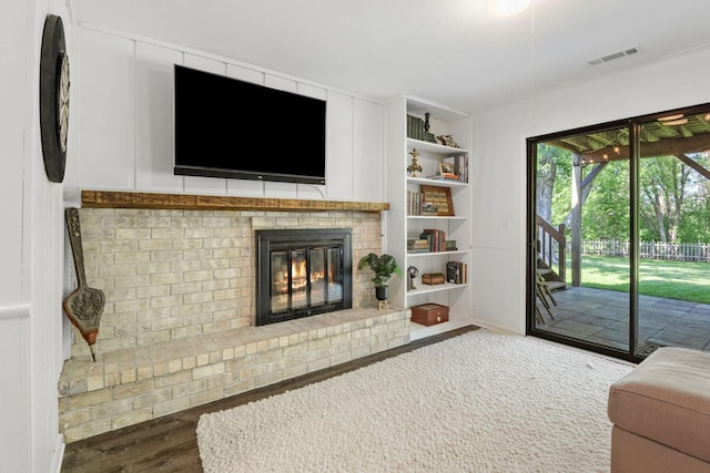 9645 Garrison Way, Eden Prairie, MN 55347 - living room with wood finished floors, a fireplace, and built in features