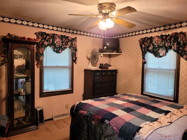 7780 Fawn Lake Dr NE, Stacy, MN 55079 - carpeted bedroom featuring multiple windows, a textured ceiling, and a ceiling fan