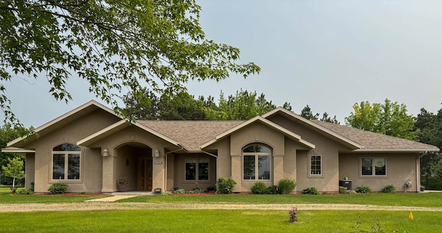 14838 Pine Ave, Little Falls, MN 56345 - ranch-style home with stucco siding, a front lawn, and a shingled roof