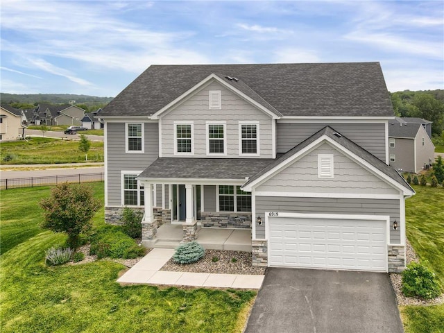 6919 156th St, Savage, MN 55378 - traditional home featuring a porch, roof with shingles, driveway, and stone siding