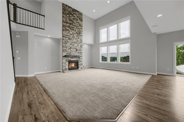 6919 156th St, Savage, MN 55378 - unfurnished living room featuring a high ceiling, a fireplace, wood finished floors, and recessed lighting