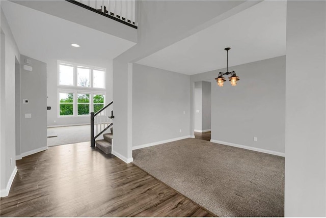 6919 156th St, Savage, MN 55378 - spare room with stairs, a chandelier, wood finished floors, and carpet floors