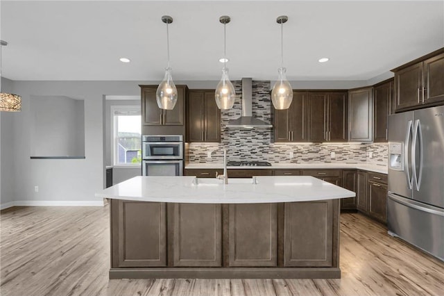 6919 156th St, Savage, MN 55378 - kitchen featuring stainless steel appliances, wall chimney exhaust hood, backsplash, dark brown cabinets, and recessed lighting