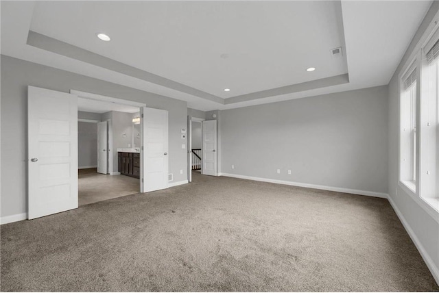 6919 156th St, Savage, MN 55378 - unfurnished bedroom featuring a raised ceiling, carpet flooring, recessed lighting, and ensuite bath