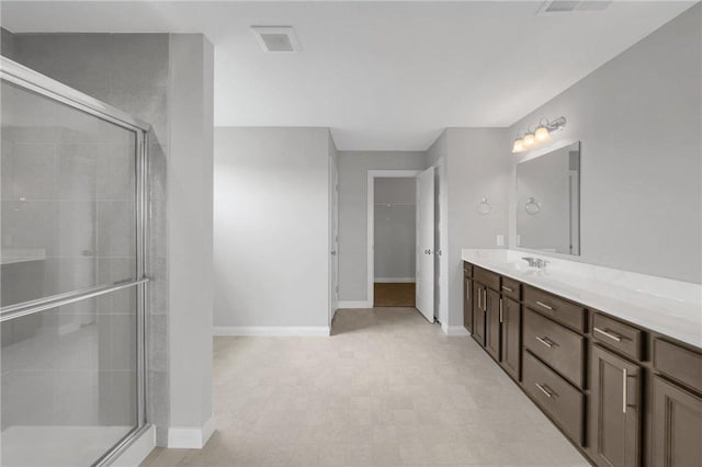 6919 156th St, Savage, MN 55378 - bathroom with vanity, a shower stall, and a walk in closet