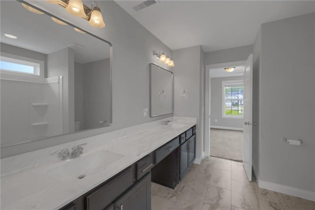 6919 156th St, Savage, MN 55378 - bathroom with healthy amount of natural light, marble finish flooring, and double vanity