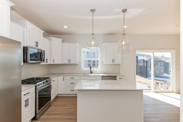 914 Milborne Ln NW, Rochester, MN 55901 - kitchen with appliances with stainless steel finishes, light wood-type flooring, healthy amount of natural light, a sink, and recessed lighting