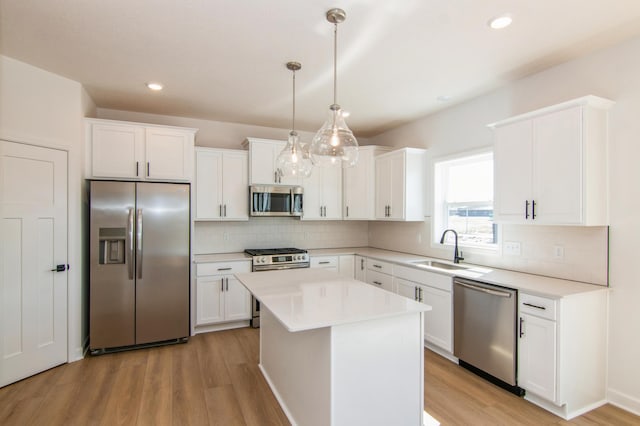 914 Milborne Ln NW, Rochester, MN 55901 - kitchen with stainless steel appliances, a sink, light wood-type flooring, decorative backsplash, and recessed lighting