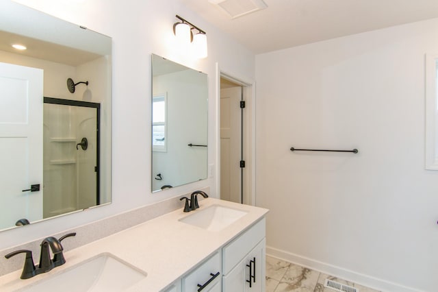 914 Milborne Ln NW, Rochester, MN 55901 - bathroom featuring double vanity, marble finish floors, a shower, baseboards, and recessed lighting