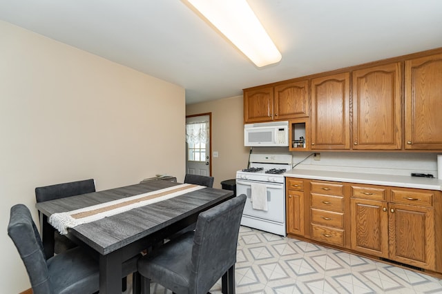 2208 17th Ave NW, Rochester, MN 55901 - kitchen featuring white appliances, brown cabinetry, and light countertops