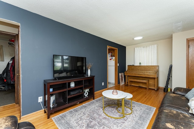 2208 17th Ave NW, Rochester, MN 55901 - living room with wood finished floors, a textured ceiling, and baseboards