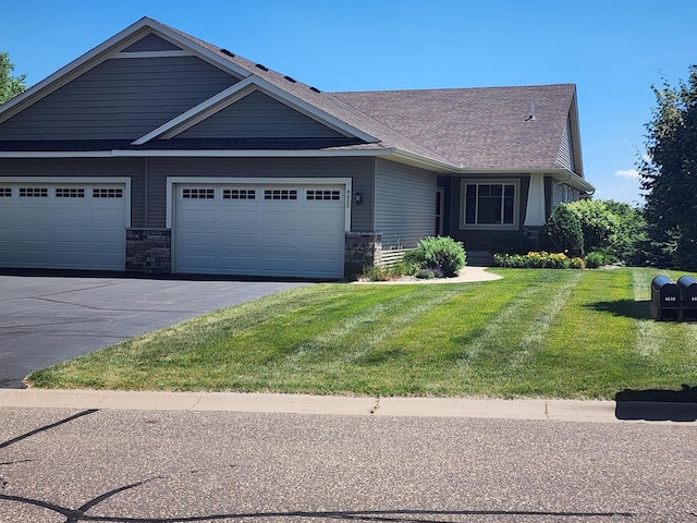 8650 Corbin Ct, Inver Grove Heights, MN 55076 - view of front of house with a front lawn, stone siding, and driveway