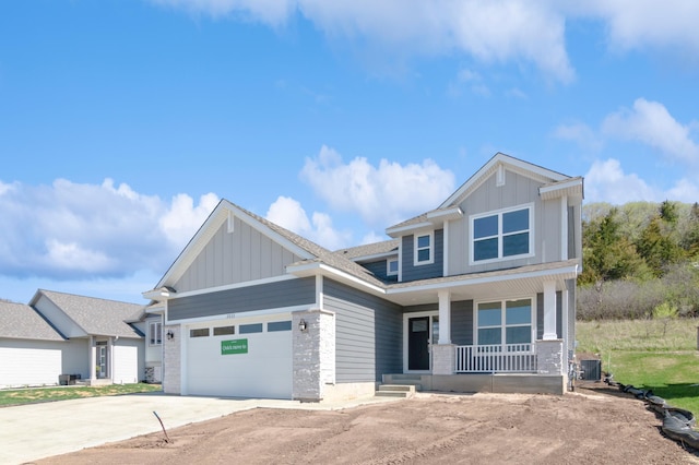 2033 Hadley Hills Dr NE, Rochester, MN 55906 - craftsman-style house featuring a porch, board and batten siding, driveway, and a garage
