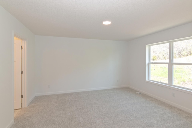 2033 Hadley Hills Dr NE, Rochester, MN 55906 - spare room featuring light colored carpet, baseboards, and recessed lighting