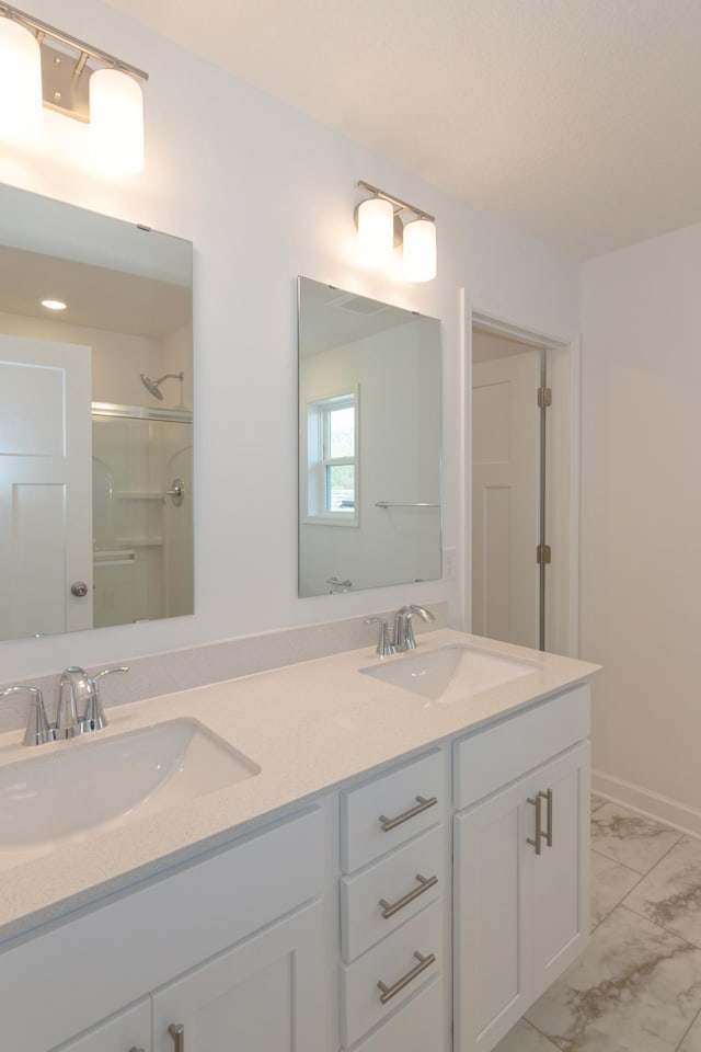 2033 Hadley Hills Dr NE, Rochester, MN 55906 - full bathroom with marble finish floors, double vanity, and a shower