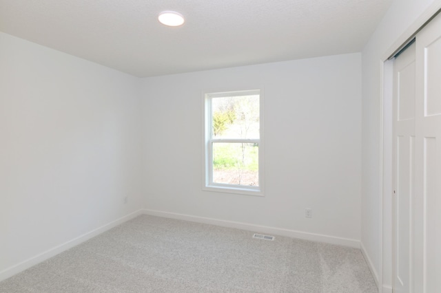 2033 Hadley Hills Dr NE, Rochester, MN 55906 - spare room with light carpet and baseboards