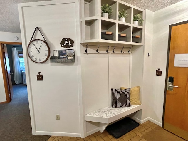 128 Bridge Run Ln Unit B, Lutsen Twp, MN 55612 - mudroom featuring a textured ceiling and baseboards