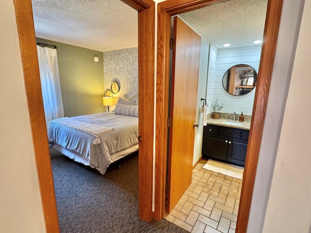 128 Bridge Run Ln Unit B, Lutsen Twp, MN 55612 - carpeted bedroom with a textured ceiling and bar with sink