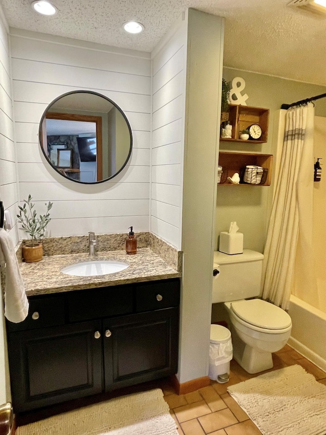 128 Bridge Run Ln Unit B, Lutsen Twp, MN 55612 - bathroom featuring toilet, vanity, wood walls, a textured ceiling, and shower / bath combo with shower curtain