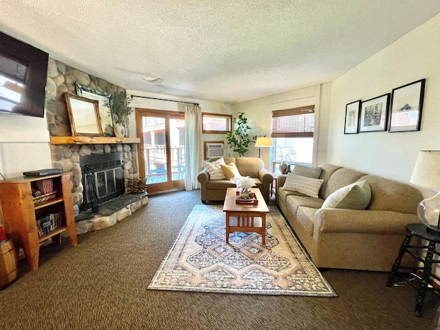 128 Bridge Run Ln Unit B, Lutsen Twp, MN 55612 - living room featuring carpet floors, healthy amount of natural light, a textured ceiling, and a stone fireplace