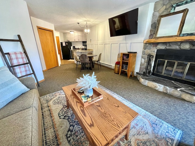 128 Bridge Run Ln Unit B, Lutsen Twp, MN 55612 - carpeted living area featuring a baseboard heating unit, a stone fireplace, and a textured ceiling