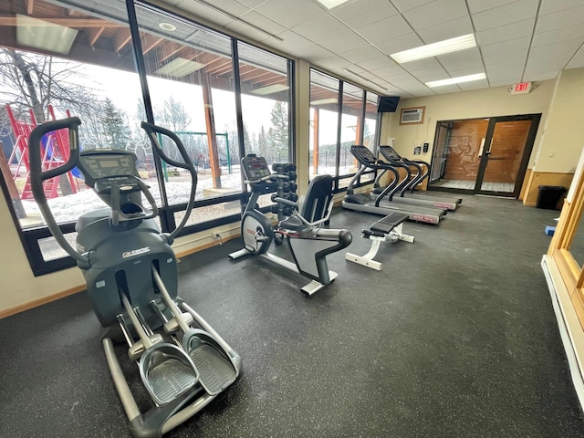 128 Bridge Run Ln Unit B, Lutsen Twp, MN 55612 - workout area featuring a drop ceiling, baseboard heating, and baseboards