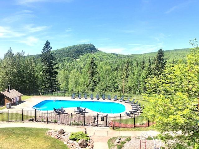 128 Bridge Run Ln Unit B, Lutsen Twp, MN 55612 - community pool featuring a view of trees and a patio area