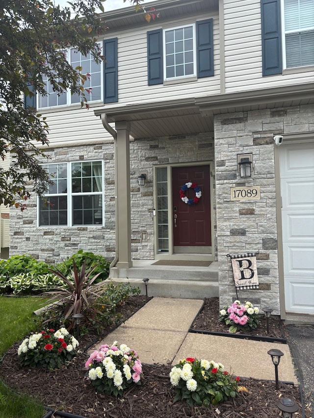 17089 76th Pl N, Maple Grove, MN 55311 - view of exterior entry featuring stone siding and a surveillance system