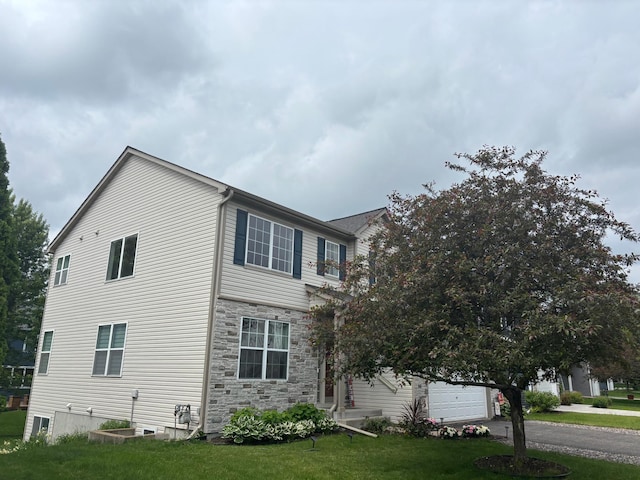 17089 76th Pl N, Maple Grove, MN 55311 - view of property exterior with driveway, stone siding, and a yard