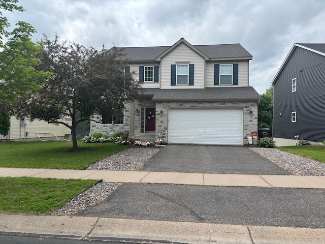 17089 76th Pl N, Maple Grove, MN 55311 - view of front of home with driveway, a front yard, an attached garage, and stone siding