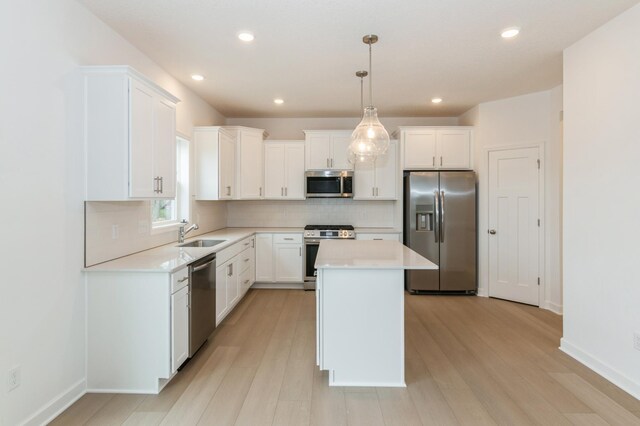 5051 52nd Ave NW, Rochester, MN 55901 - kitchen featuring stainless steel appliances, a center island, tasteful backsplash, light countertops, and recessed lighting