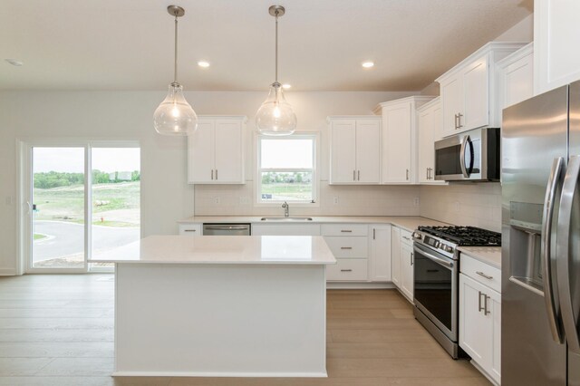 5051 52nd Ave NW, Rochester, MN 55901 - kitchen featuring stainless steel appliances, a sink, decorative backsplash, light wood-style flooring, and recessed lighting