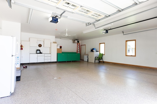 1120 Southridge Rd, New Ulm, MN 56073 - garage featuring freestanding refrigerator, a garage door opener, and washing machine and dryer