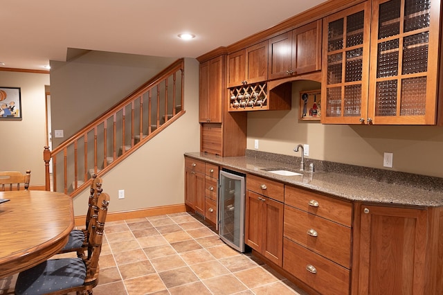 1120 Southridge Rd, New Ulm, MN 56073 - kitchen with beverage cooler, a sink, brown cabinets, glass insert cabinets, and recessed lighting