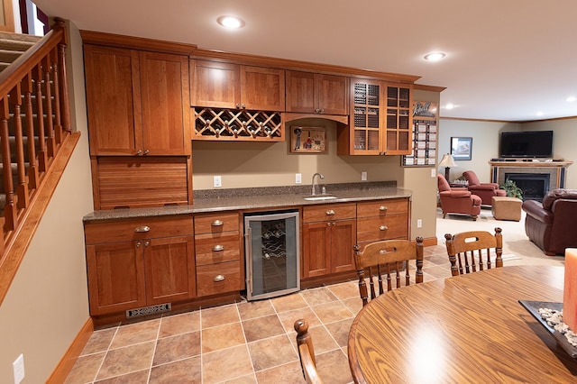 1120 Southridge Rd, New Ulm, MN 56073 - indoor wet bar with beverage cooler, stairs, a fireplace, baseboards, and recessed lighting