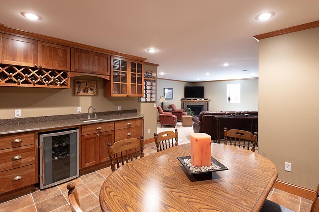 1120 Southridge Rd, New Ulm, MN 56073 - dining area featuring wine cooler, wet bar, light tile patterned floors, recessed lighting, and ornamental molding