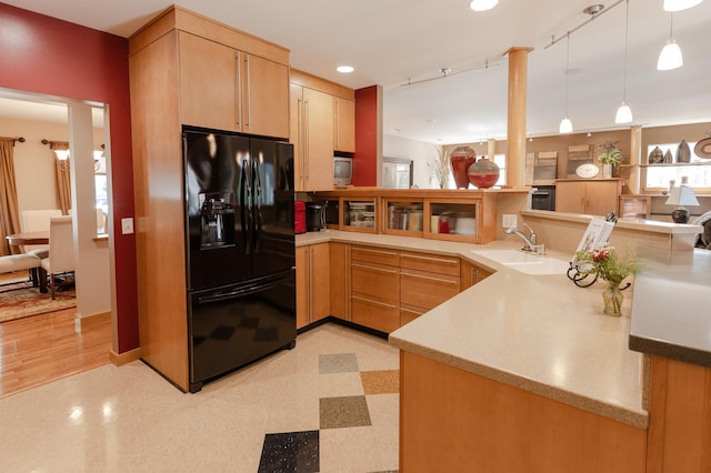 1120 Southridge Rd, New Ulm, MN 56073 - kitchen with black fridge with ice dispenser, light brown cabinetry, a sink, a peninsula, and light flooring