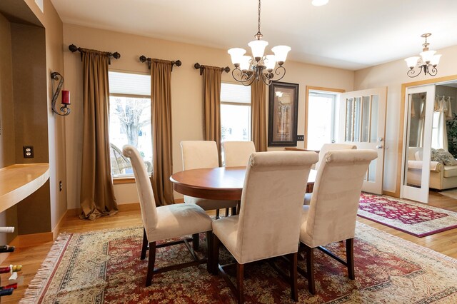 1120 Southridge Rd, New Ulm, MN 56073 - dining room with a chandelier, wood finished floors, and baseboards