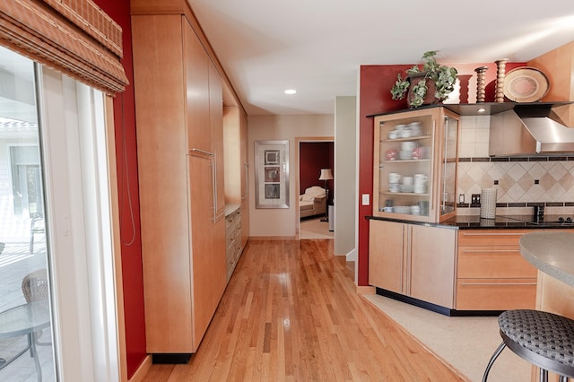 1120 Southridge Rd, New Ulm, MN 56073 - indoor wet bar featuring decorative backsplash, light wood-style floors, wall chimney range hood, recessed lighting, and baseboards