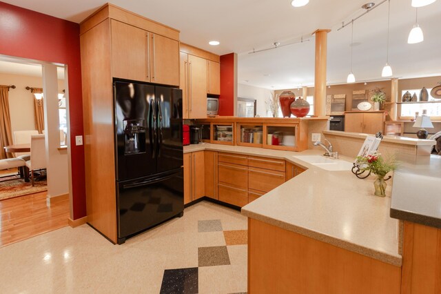 1120 Southridge Rd, New Ulm, MN 56073 - kitchen featuring black fridge, a sink, a peninsula, light brown cabinets, and light floors