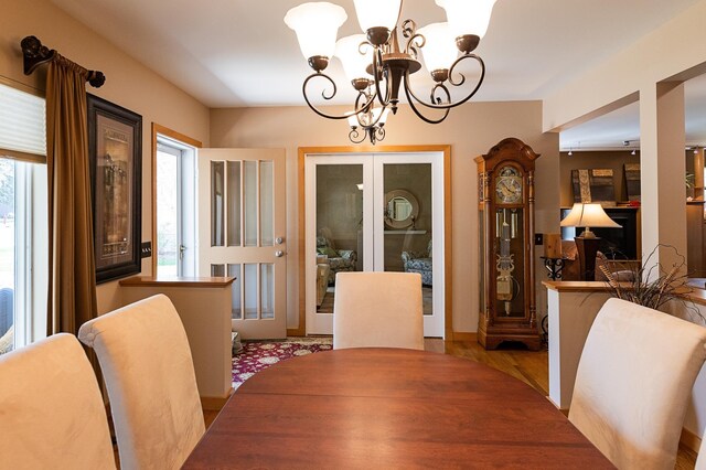 1120 Southridge Rd, New Ulm, MN 56073 - dining space featuring a chandelier, plenty of natural light, and wood finished floors