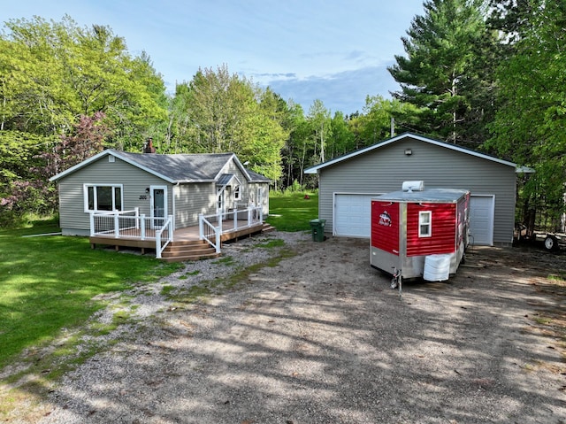 11966 Lindquist Rd, Hibbing, MN 55746 - view of front of home featuring a garage, a deck, an outbuilding, and a front lawn