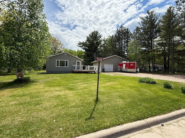 11966 Lindquist Rd, Hibbing, MN 55746 - single story home featuring a wooden deck, dirt driveway, a front yard, a detached garage, and view of scattered trees