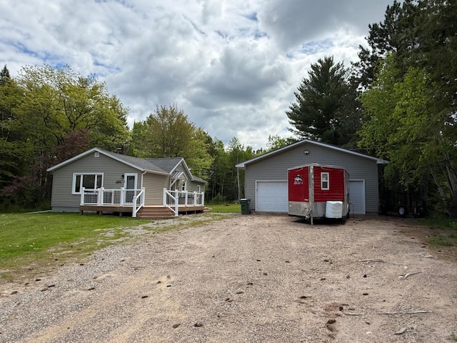 11966 Lindquist Rd, Hibbing, MN 55746 - view of front facade featuring a garage, a deck, and an outdoor structure