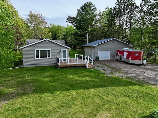 11966 Lindquist Rd, Hibbing, MN 55746 - view of front of house featuring a deck, a garage, an outbuilding, and a front lawn